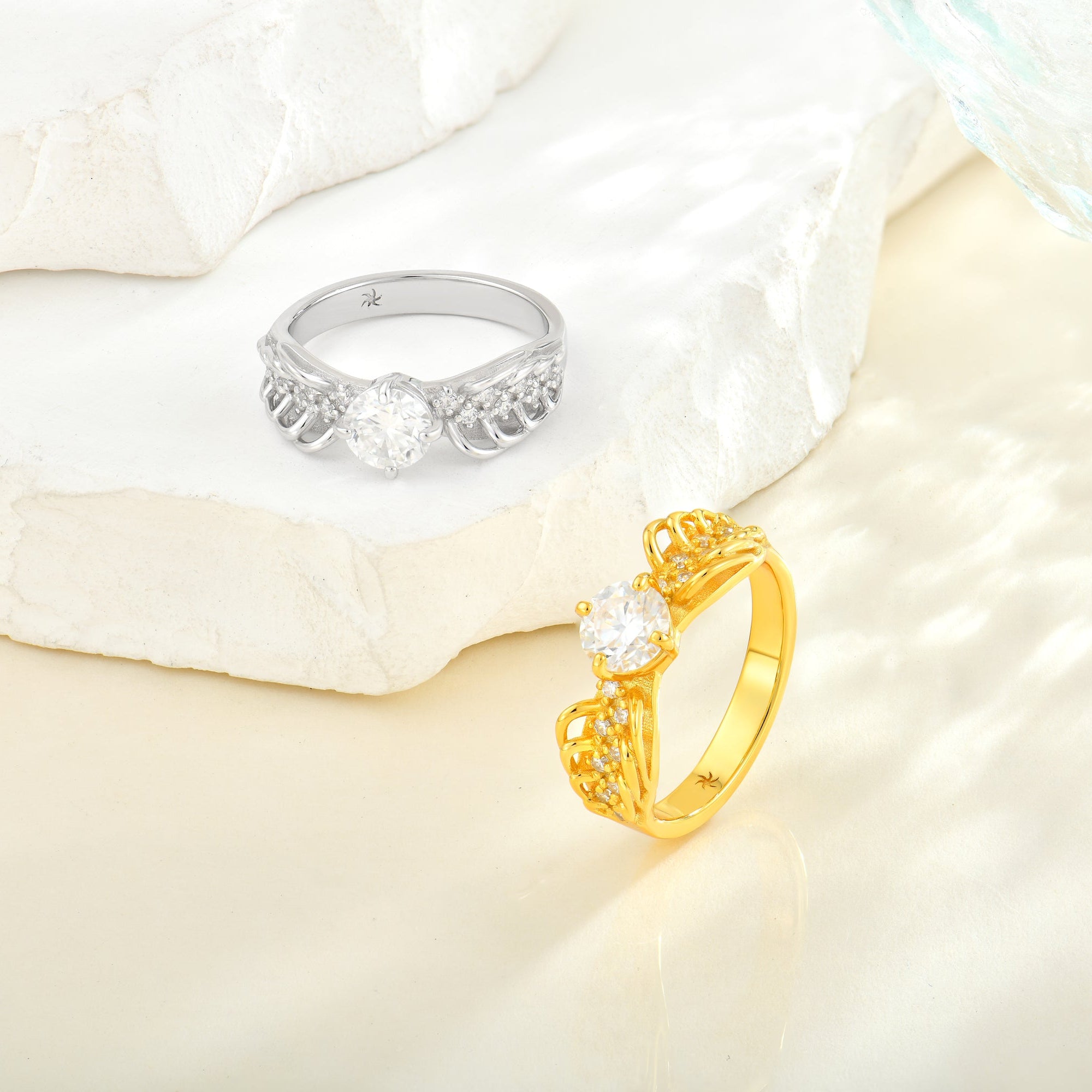 Gold and silver rings on a soft white fabric background