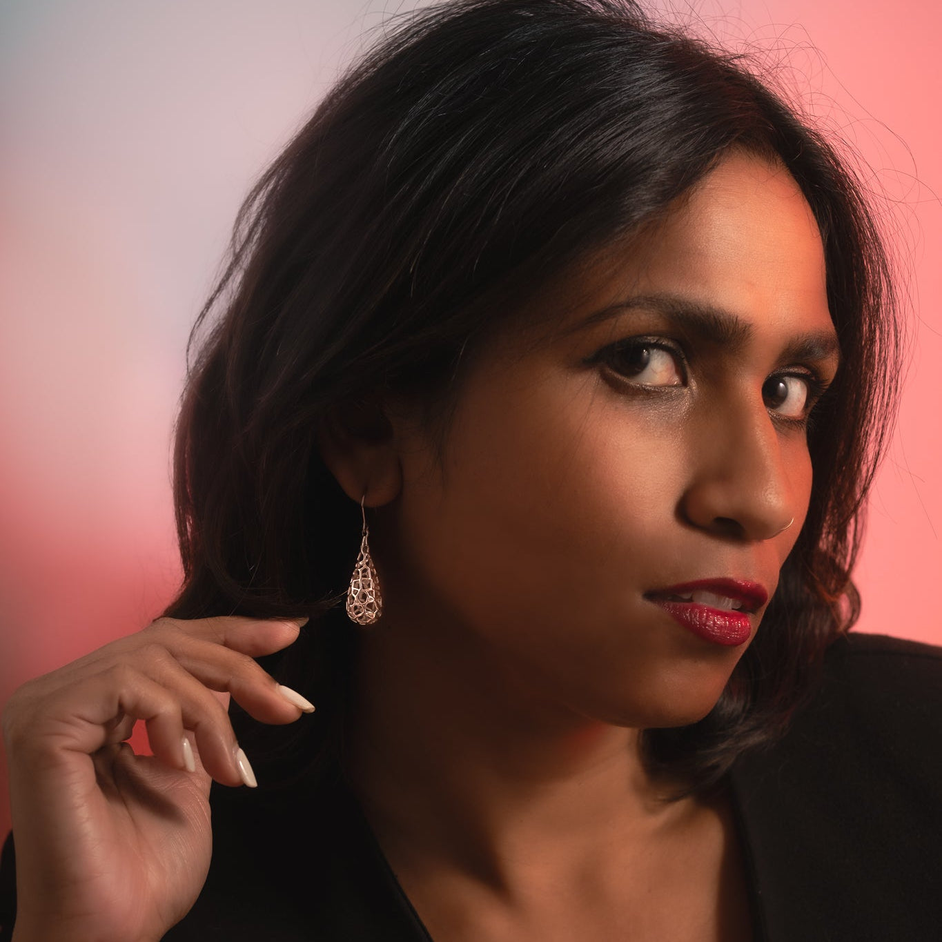 Woman wearing a black top with a blurred background
