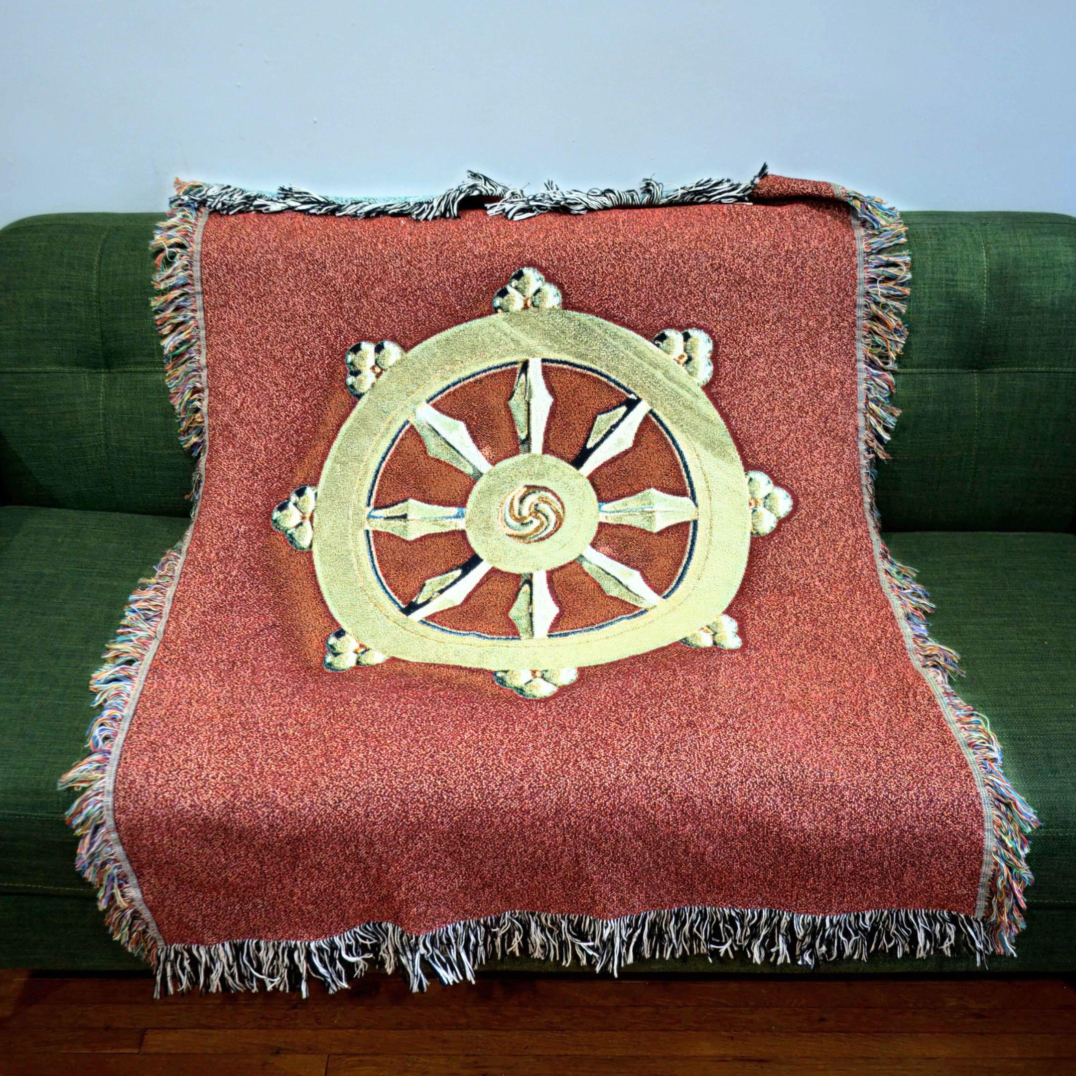 red dharma wheel blanket on green couch