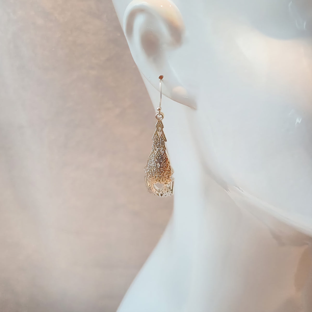 Gold Cellular Automata earring worn on a mannequin