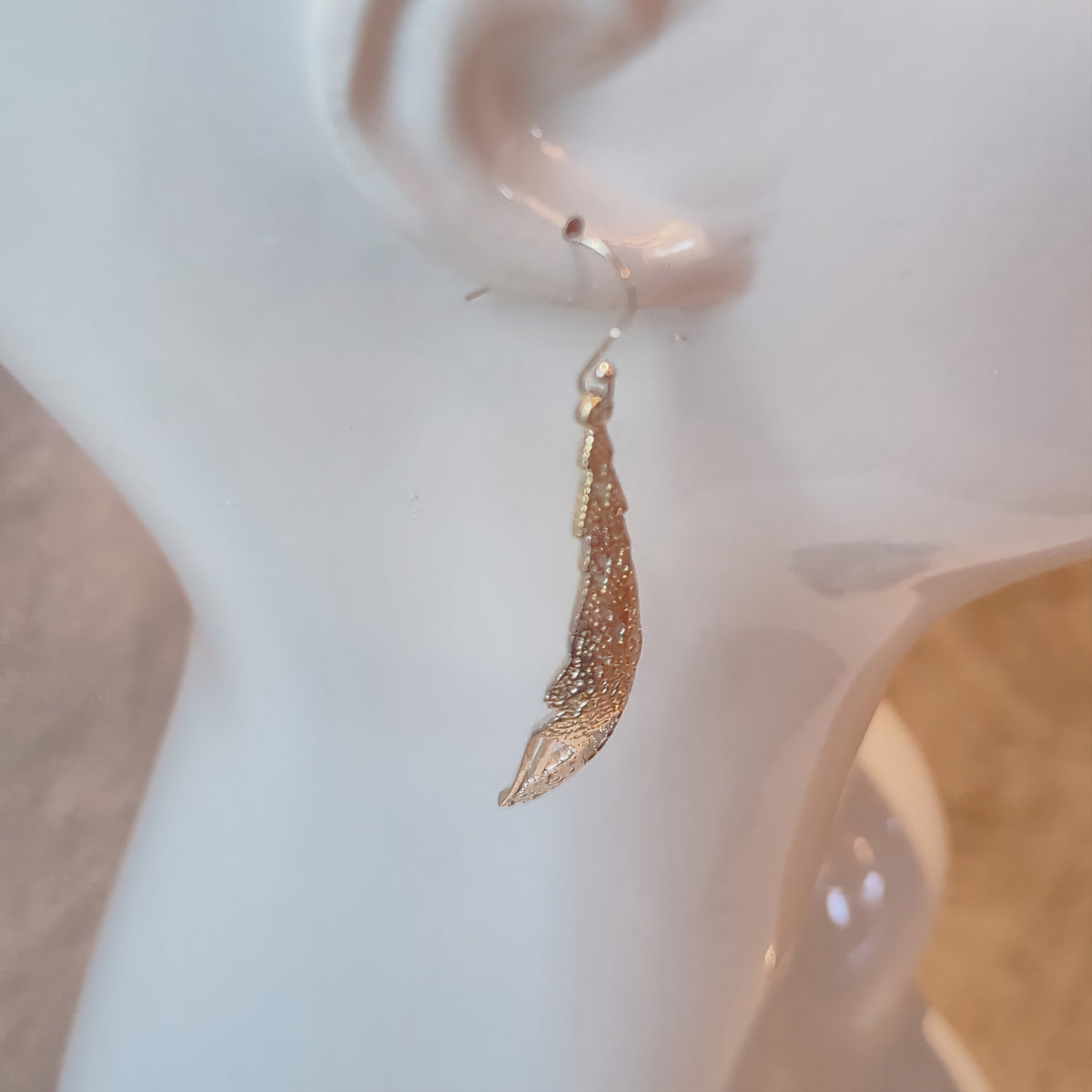 Silver Cellular Automata earring on a mannequin, side view