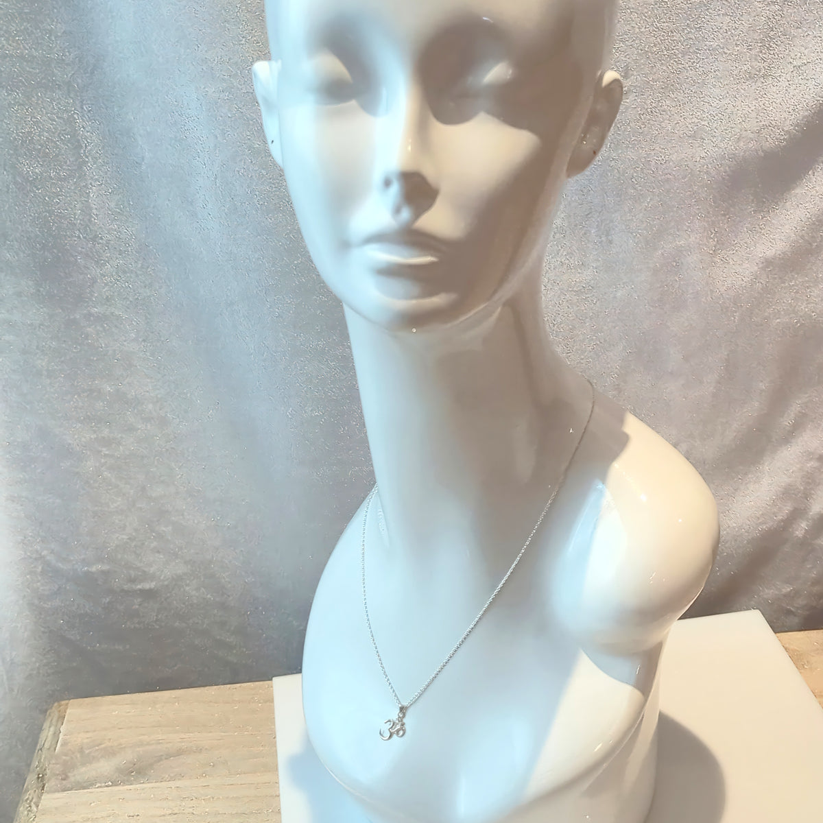 Mannequin wearing the Classic Om Pendant in silver