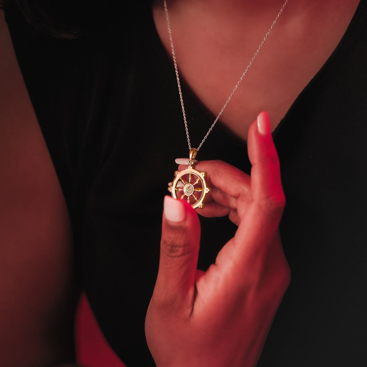 Model wearing the gold Dharmachakra pendant
