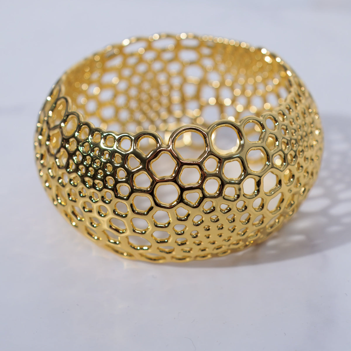 Gold Foam Bangle with bubble-like openings on a white background