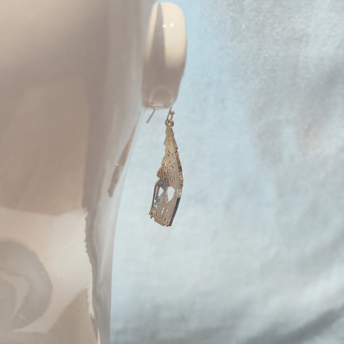 Cellular Automata dangle earring on a mannequin, viewed from behind