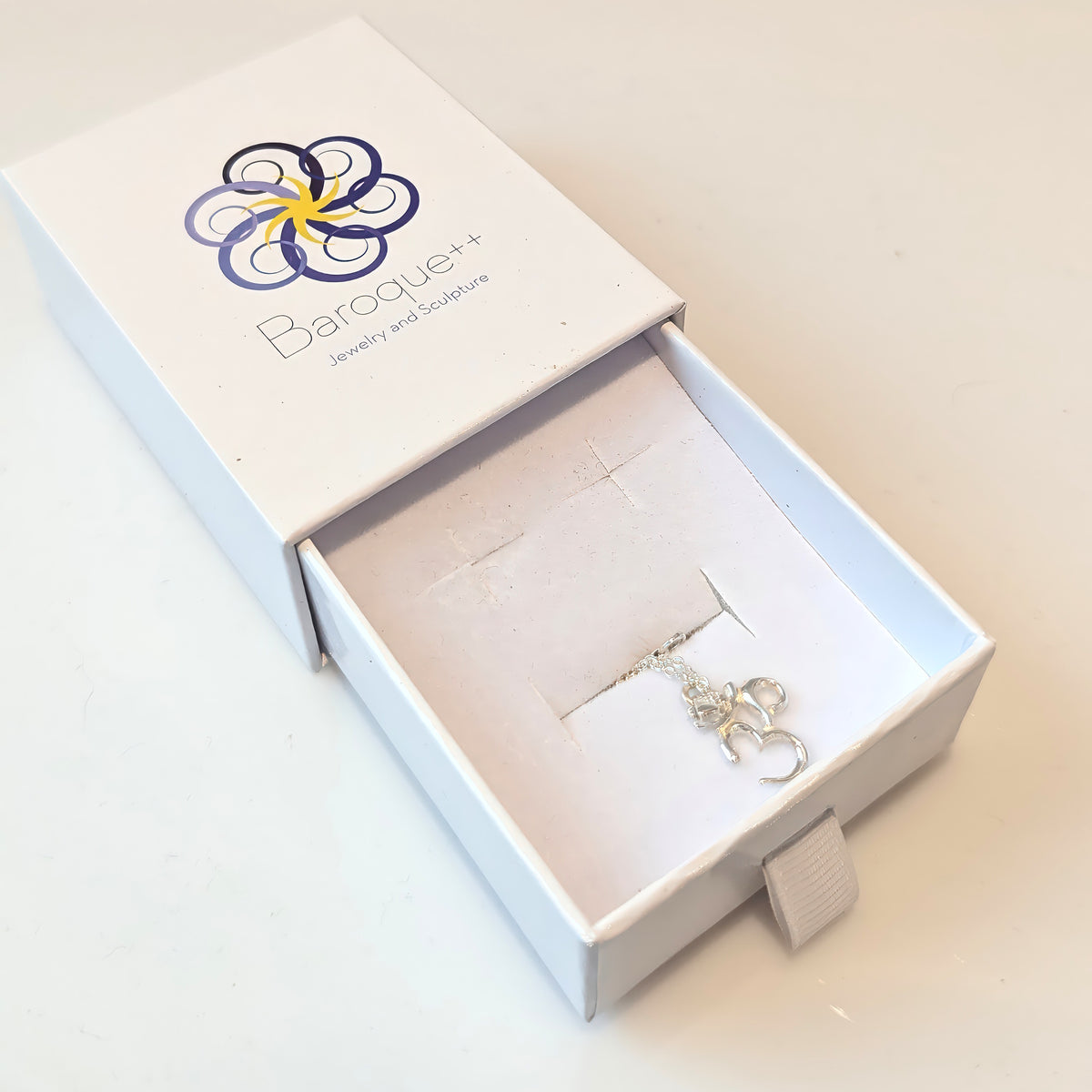 Silver Classic Om pendant in a Baroque++ jewelry box