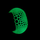Glowing green bangle bracelet on a wrist on a black background in the dark