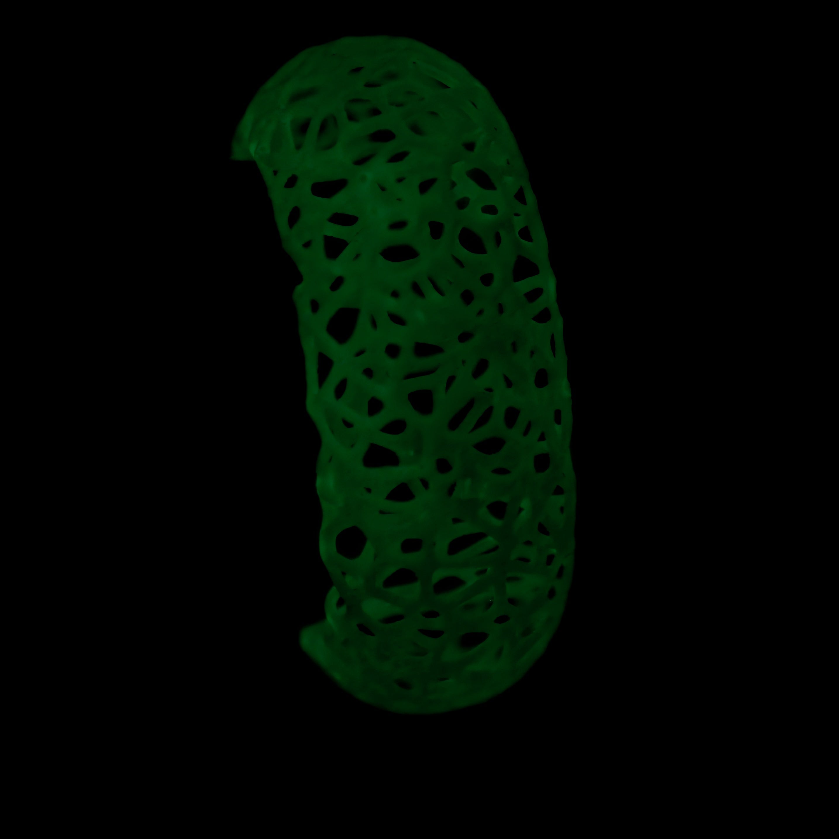 Glowing green bracelet on a black background