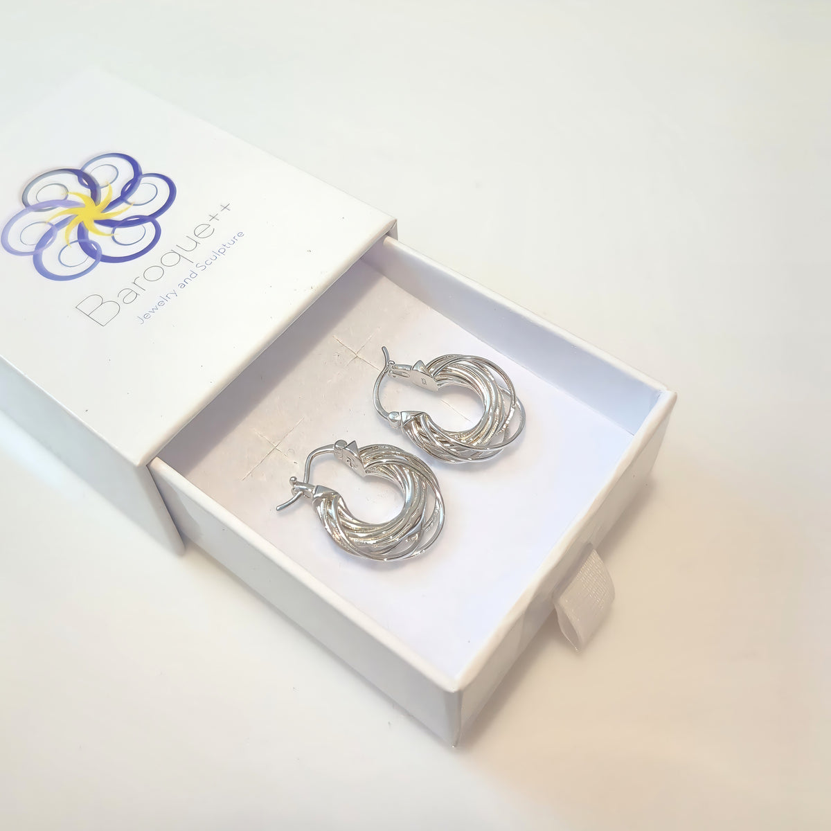Silver Orbit hoop earrings in a Baroque++ jewelry box