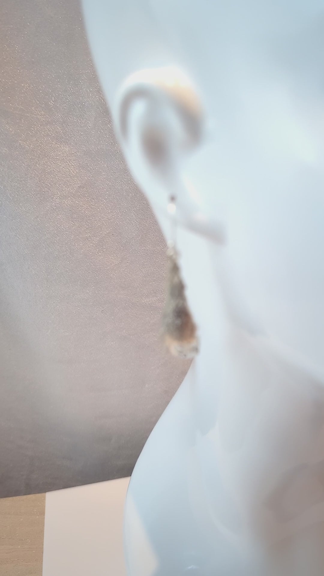 A video showcasing the angle earrings on a mannequin with chillop music.