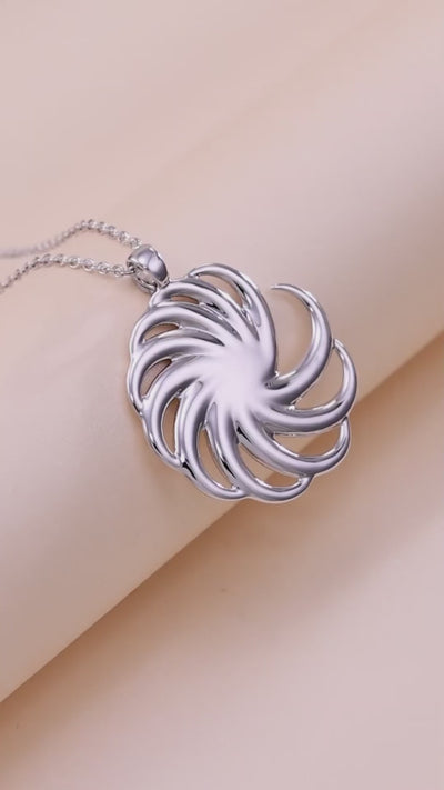 a video of a spiral pendant close up and on a model with chillhop music