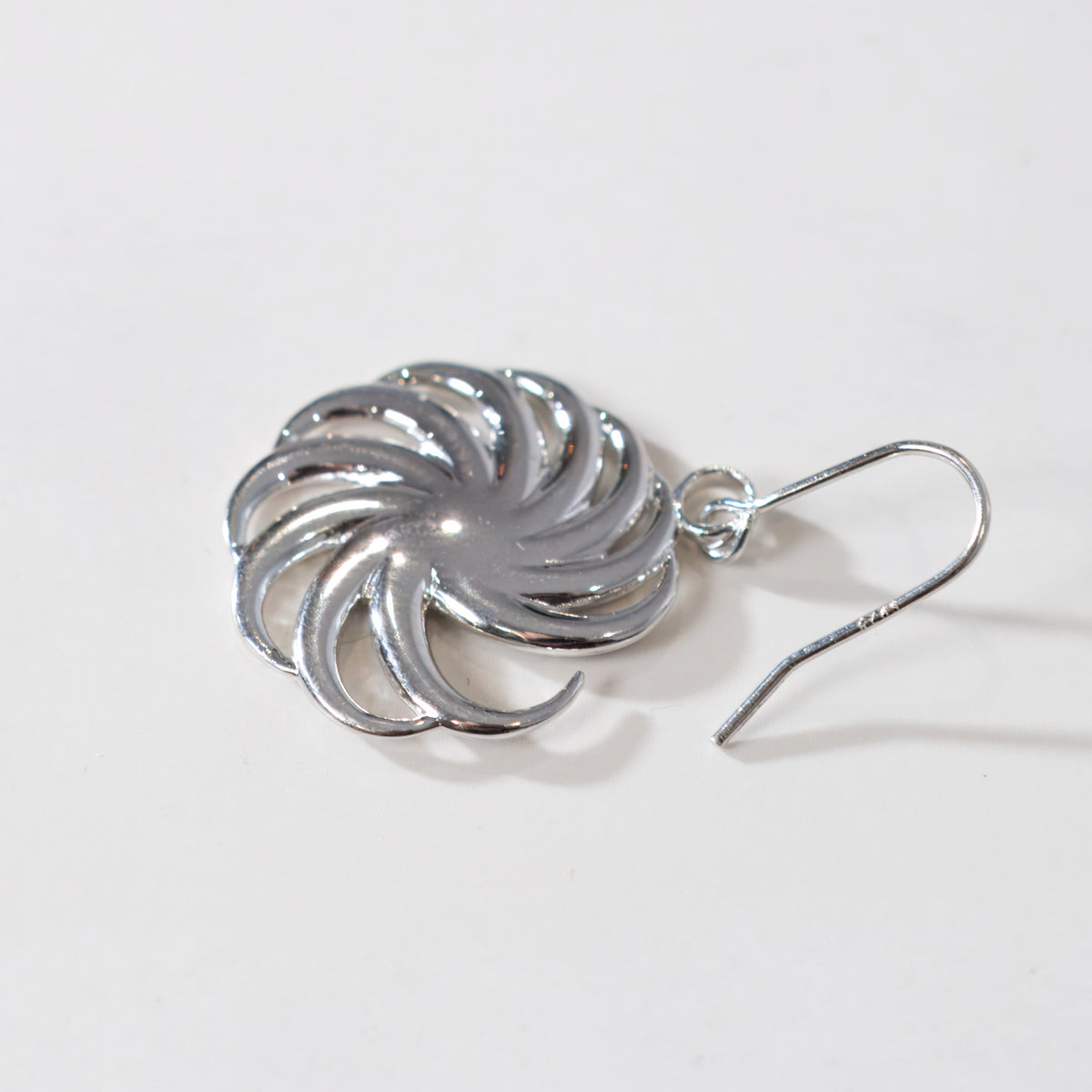 Single silver Spiral earring on a white background