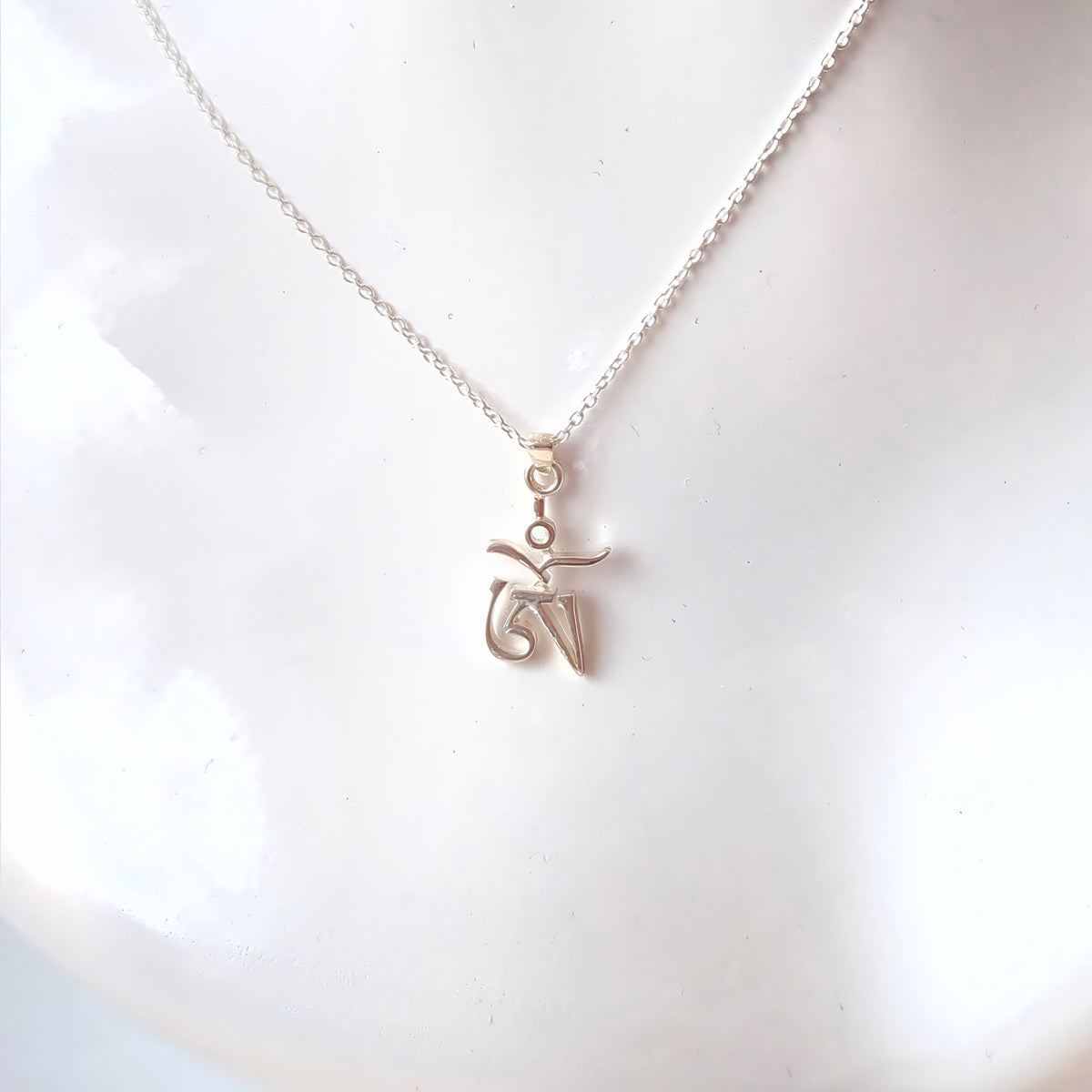 Tibetan Om pendant on a silver chain